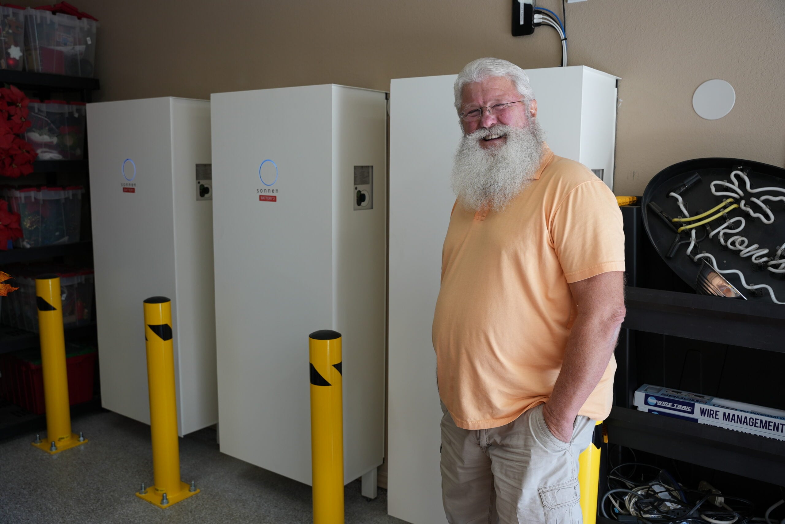 Home battery system installed alongside a generator in a garage